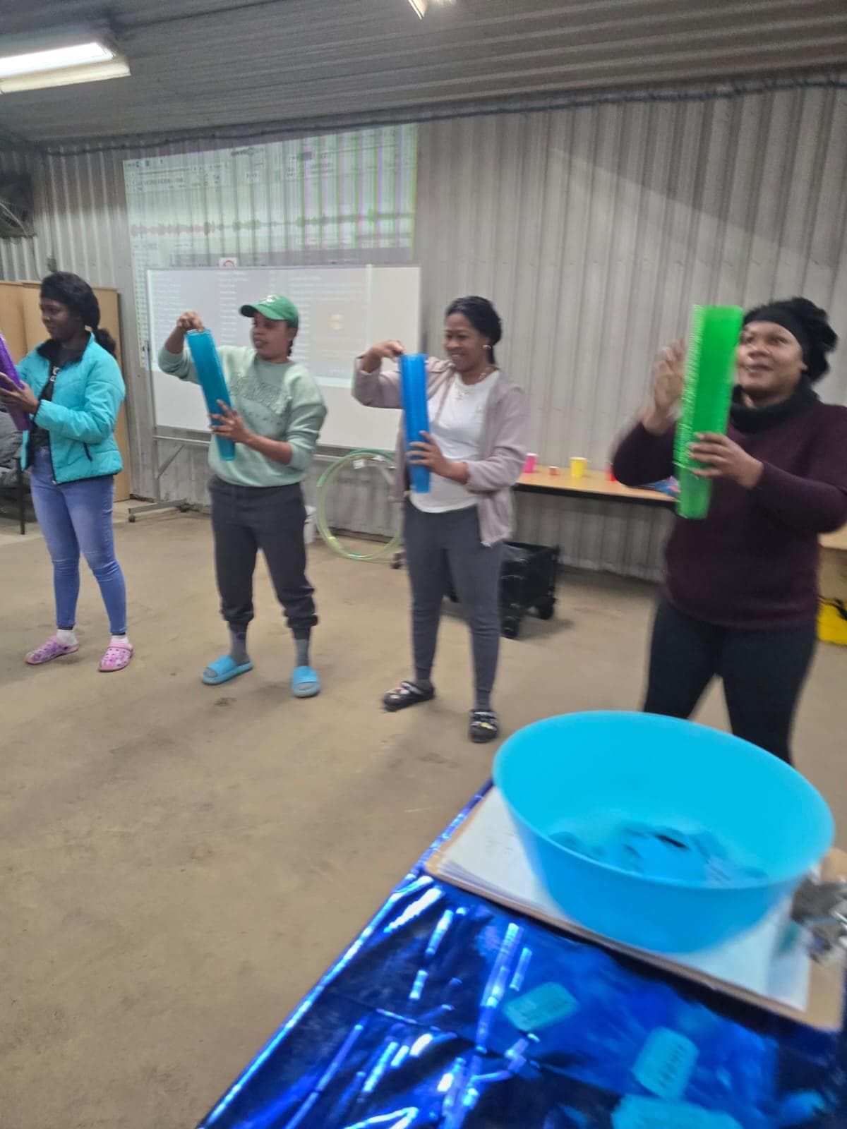Women enjoying team games and activities in a barn