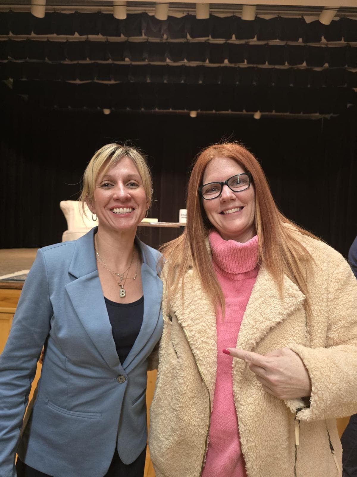 Staff members at a raffle and information booth at a community event