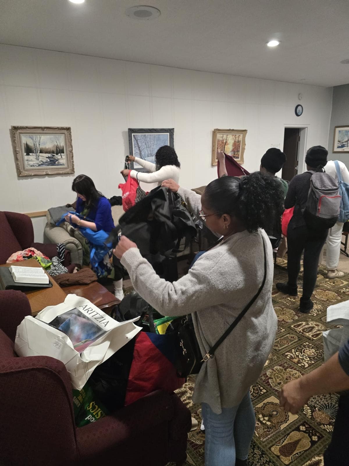 Community members sorting donated clothing at a clothing swap event