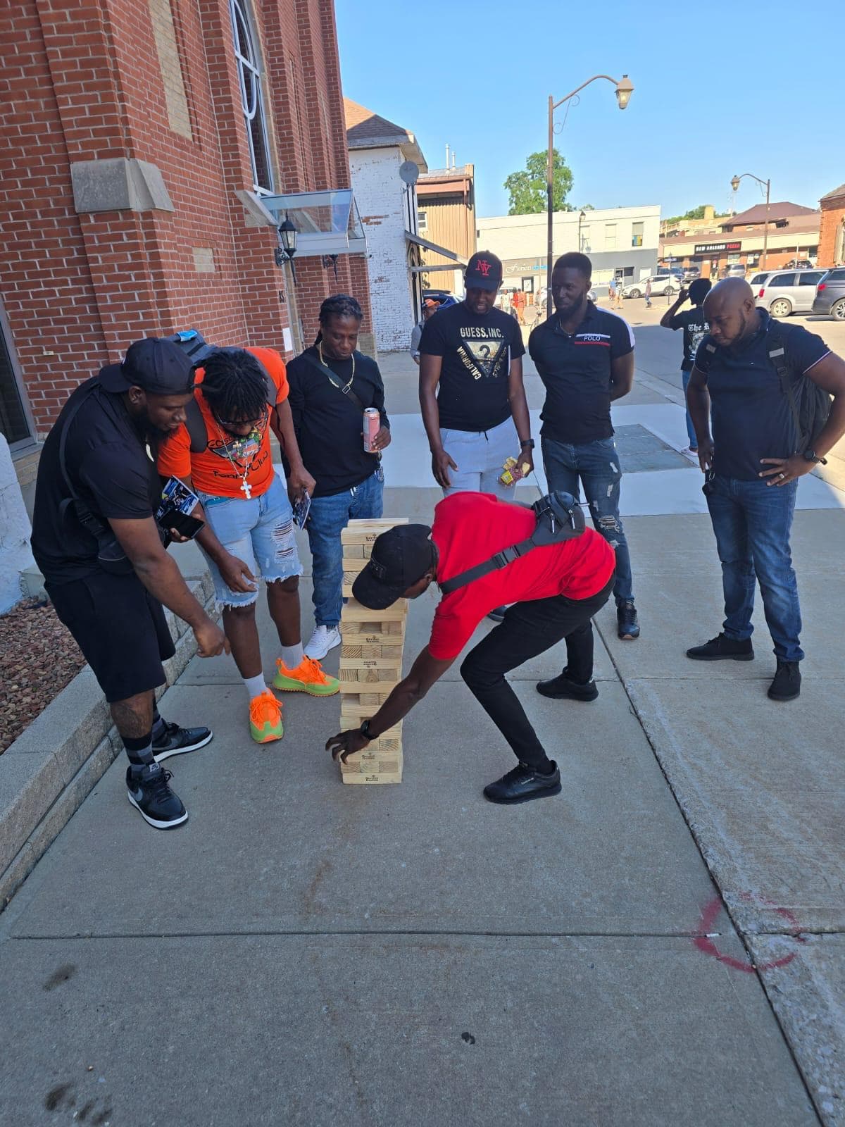 Community members playing giant Jenga outside a local church