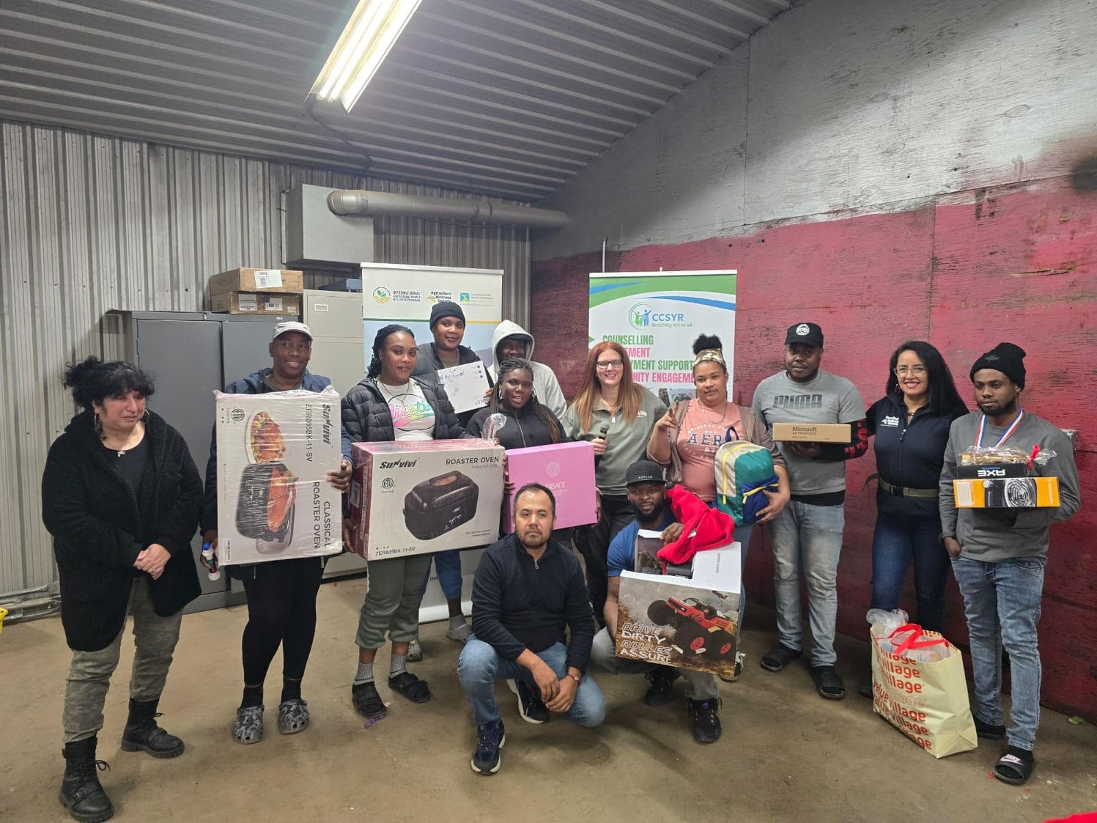 Community members with prizes at a barn event celebration
